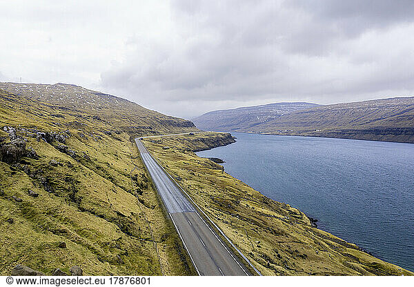 Remote highway stretching along edge of fjord