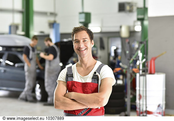 Repair garage  car mechanic  smiling