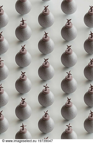 Repeated pattern of pink bombs on white background