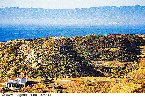 Report Illegal migration from Morocco to Spain. People from Africa are trying to get to the territory of the European Community (today: European Union) for a variety of reasons. A large proportion of immigrants attempt the sea route from Morocco to Spain  using small keelless wooden boats ( pateras ) with outboard motors. Some also try to hide on ferries from Morocco to Algeciras (Spain).
Here: the Moroccan coast  in the background the Mediterranean Sea and the Spanish coast near Tarifa.
Morocco  1993.