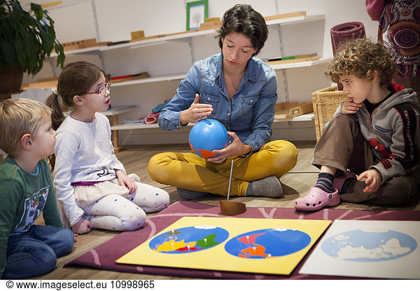 Reportage in a bilingual Montessori school in Haute-Savoie  France  which caters for children from 2 to 6 years old. The 2-6-year olds are all in the same class to encourage socialisation : the older ones look after the younger ones  which boosts self-confidence in the older ones and increases motivation to work in the younger ones. Montessori education psychology used in the school aims to develop the autonomy  desire and curiosity of the child. “Every useless help given to the child becomes an obstacle to its development said Maria Montessori. The children have specific materials available  each can choose the exercise they wish to carry out. In this exercise  the children learn how to recognise the various continents on the globe.