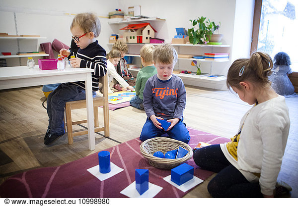Reportage in a bilingual Montessori school in Haute-Savoie  France  which caters for children from 2 to 6 years old. The 2-6-year olds are all in the same class to encourage socialisation : the older ones look after the younger ones  which boosts self-confidence in the older ones and increases motivation to work in the younger ones. Montessori education psychology used in the school aims to develop the autonomy  desire and curiosity of the child. “Every useless help given to the child becomes an obstacle to its development said Maria Montessori. The children have specific materials available  each can choose the exercise they wish to carry out. In this exercise  the child must recognise various geometric shapes.