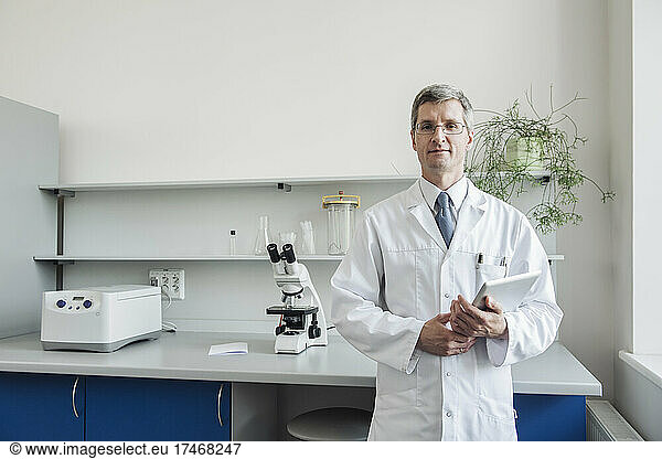 Researcher holding tablet PC in laboratory