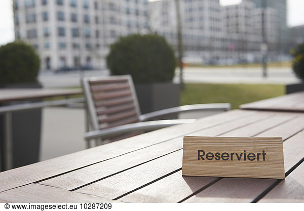 Reserved sign on the table in a sidewalk cafe  Munich  Bavaria  Germany