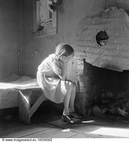 Resettled Farm Child from Taos Junction to Bosque Farms Project  Portrait Sitting near Fireplace  Mills  New Mexico  USA  Dorothea Lange  Farm Security Administration  December 1935