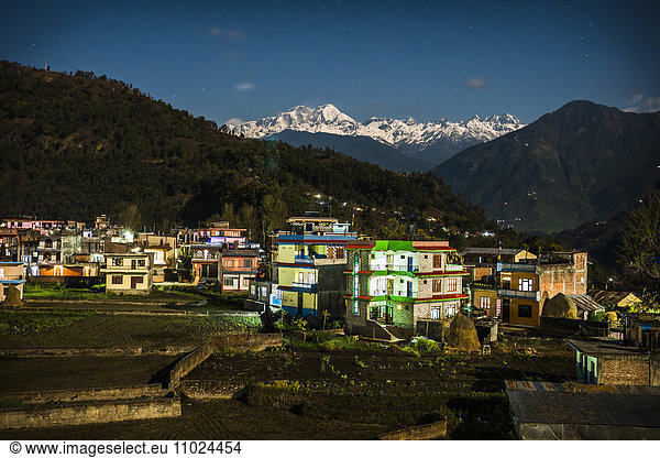 Residential district and mountains against clear sky in Besisahar at dusk