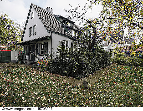 Residential house with garden in autumn