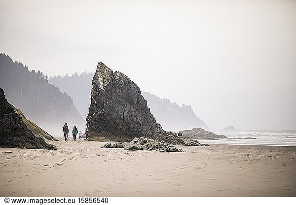 Retired couple take a long walk on Oregon Coast beach.