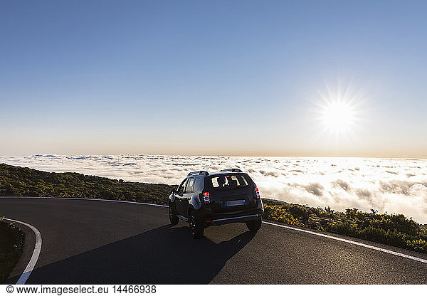 Reunion  Reunion National Park  car on the road to Maido viewpoint  sea of clouds and sunlight