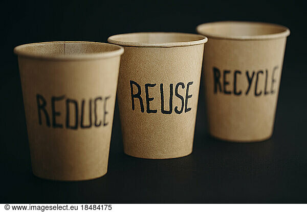 Reusable cups arranged against black background