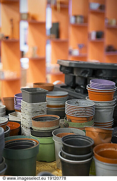 Reused plant pots stacked on table at recycling center
