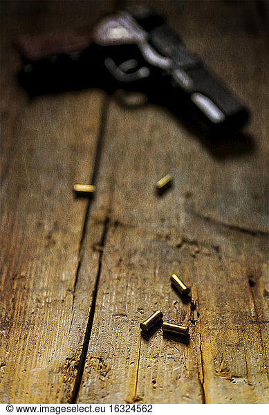 Revolver and cartridges on wood