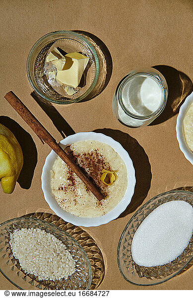 rice pudding with its ingredients on a brown background