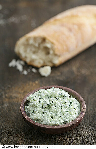 Ricotta ramson cream and piece of baguette  close up