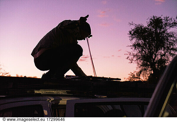 Rigging Overlanding Setup Before Sunrise in African Wilderness