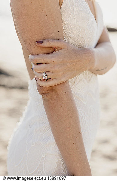 Ring of a bride wearing white wedding dress
