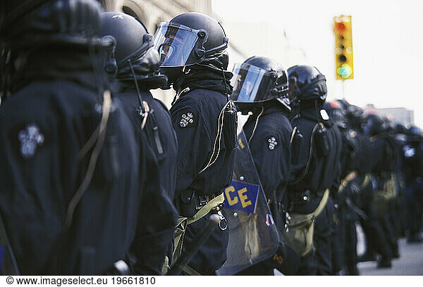 Riot police from the RCMP and Ontario Provincial Police (OPP) stand guard at the G20 protests in Ottawa during 2001.