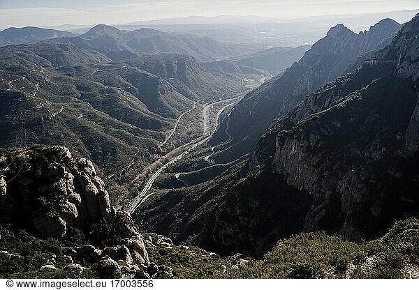Riverside road stretching along valley in Montserrat range