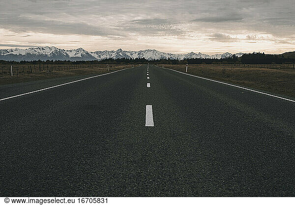 Road heading towards Southern Alps mountains  New Zealand