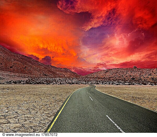 Road in desert on sunset