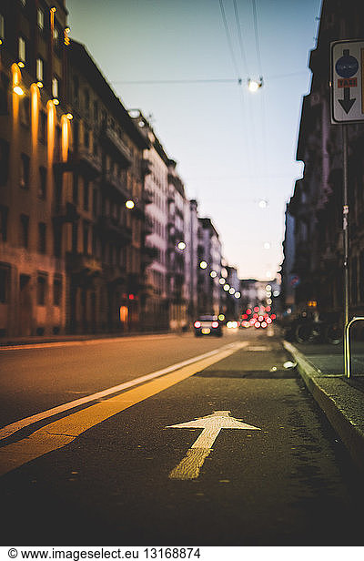 Road with arrow marking at dusk  Milan  Italy