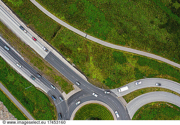 Roads leading to and from a roundabout seen from above.