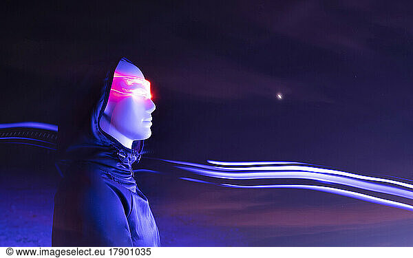 Robot with glowing futuristic eyeglasses standing by light trail