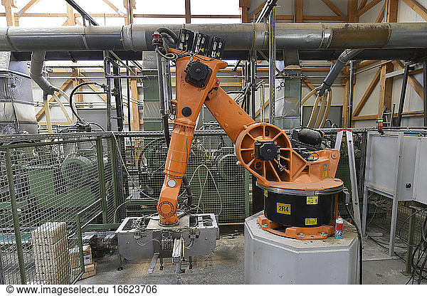 Robotic arm operating in modern lumberyard