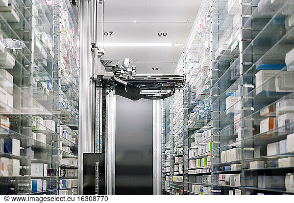 Robotic pharmacy amidst shelves in hospital