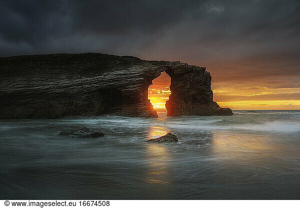 Rock arch in Las Catedrales Beach at sunset in Ribadeo  Spain