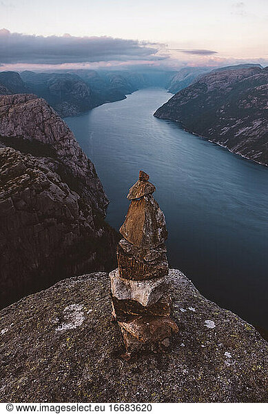 rock pile and view of Norwegian fjords in cloudy day