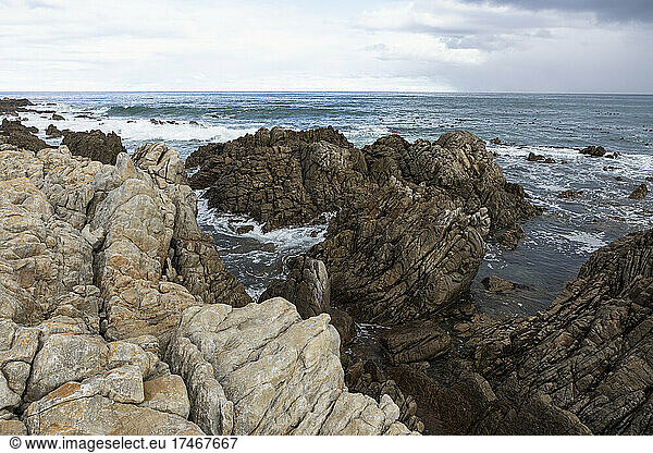 Rocky jagged coastline  eroded sandstone rock  view out to the ocean