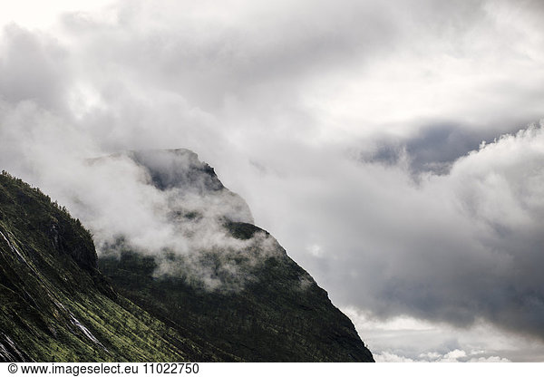 Rocky mountain against cloudy sky