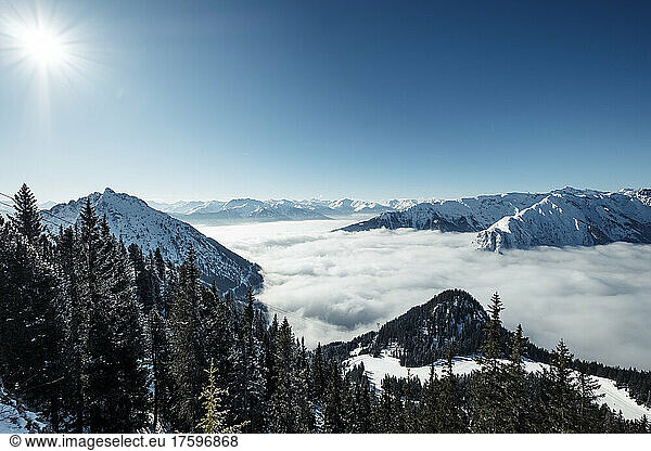 Rofan Mountains on sunny winter day with heavy fog over Achen Lake and Inntal