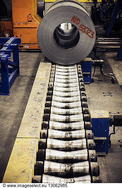 Rolled up sheet metals on machinery at warehouse