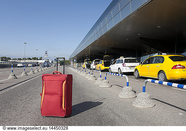 Rolling Luggage Outside an Airport Terminal