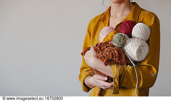 Rolls of cotton ropes in woman hand. Knitting  crocheting  handm