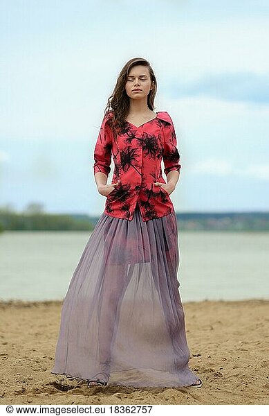 Romantic and mystical image of a woman in transparent skirt and jacket with prints