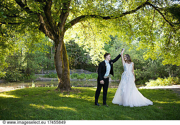 Romantic couple dancing in a park.