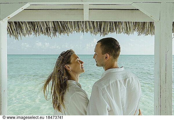 Romantic couple enjoying vacation by sea