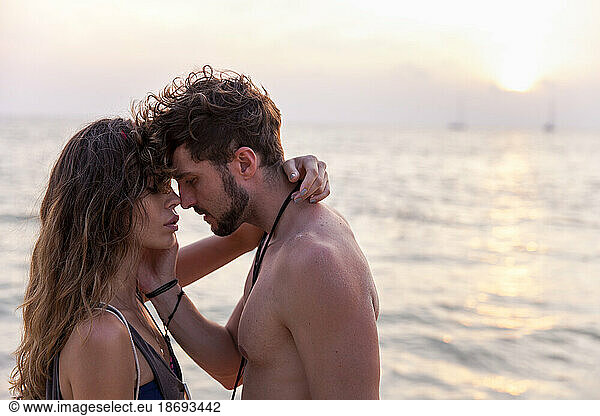 Romantic couple face to face in front of sea