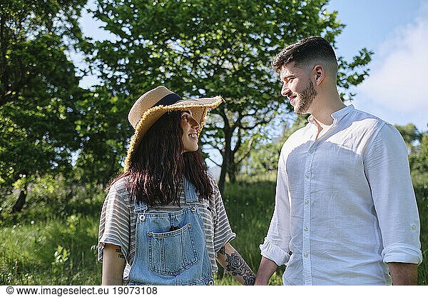 Romantic couple holding hands at park