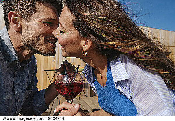 Romantic couple kissing on table at beach