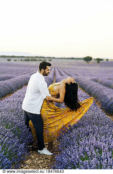Romantic couple standing in lavender field