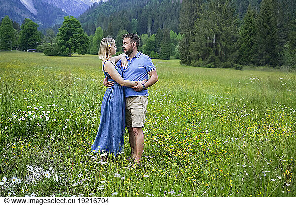 Romantic couple standing in meadow
