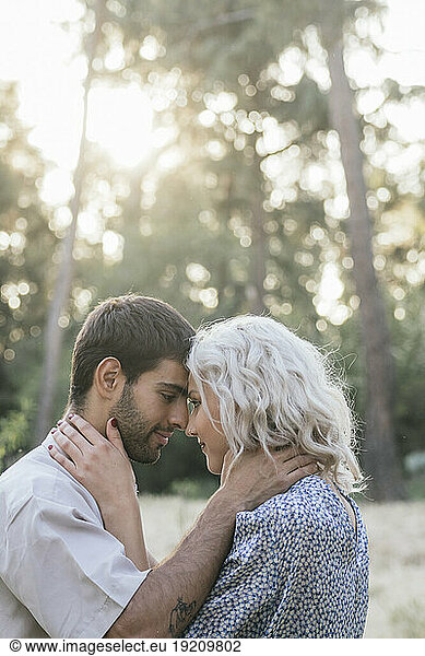 Romantic couple staring at each other on sunny day