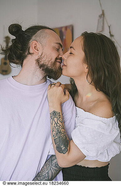 Romantic hipster couple kissing each other