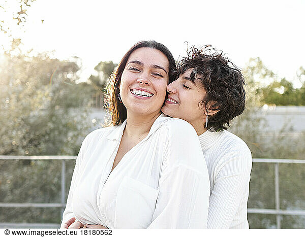 Romantic lesbian couple wearing white clothes enjoying together