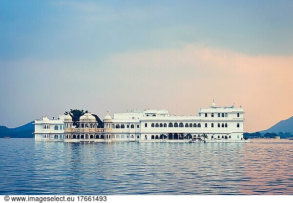 Romantic luxury India travel tourism  Lake Palace (Jag Niwas) complex on Lake Pichola on sunset with dramatic sky  Udaipur  Rajasthan  India
