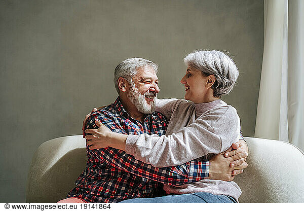 Romantic mature couple embracing at home